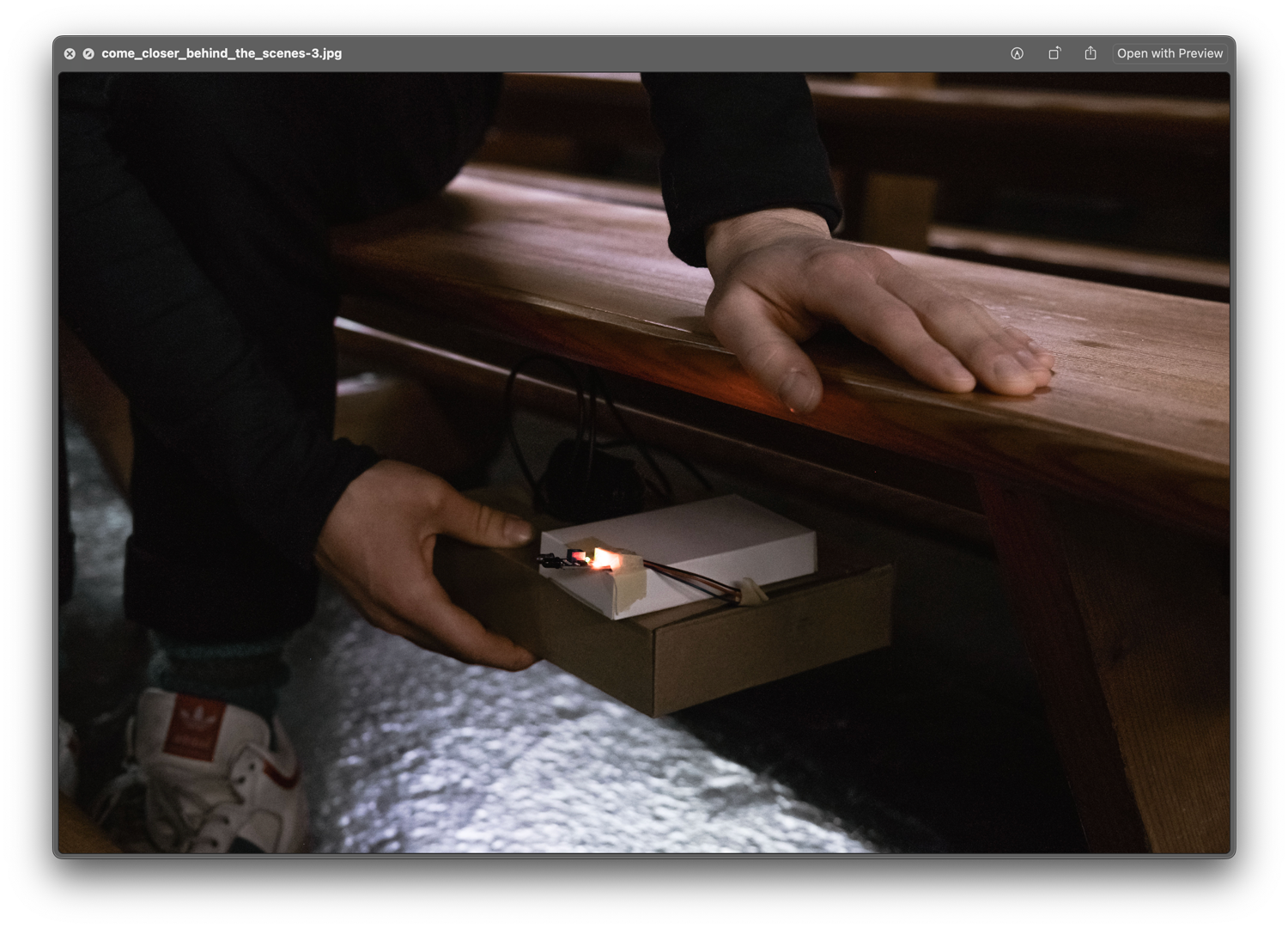 Attaching part of the installation to the bottom of a church bench